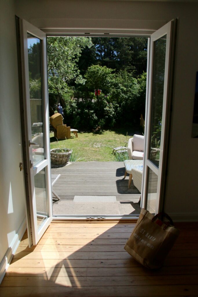 Offene Terrassentür mit Blick auf den grünen Garten